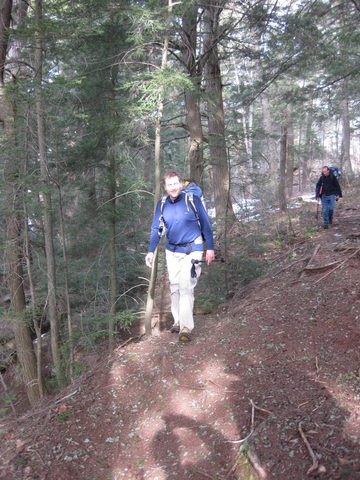 Tim walks along the cliff edge above Steep Rise lake.