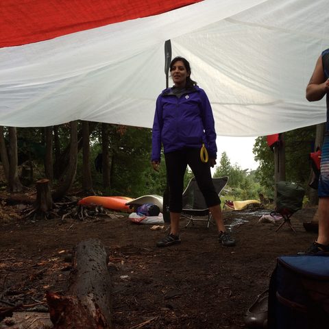 Saveena took a turn holding up the tarp, placing the little paddle on her shoulder.  And no, you may NOT light the fire yet - we'll need all that firewood for the long night ahead. And we did - good call Saveena.  #Rogella.  (you owe me, Mike)